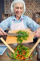 Woman cutting salad greens