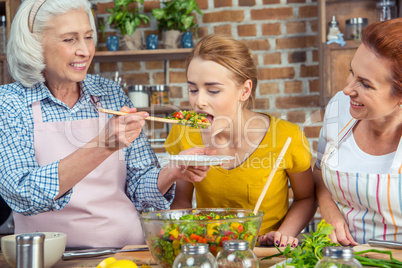 Woman tasting vegetable salad