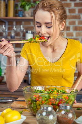 Woman tasting vegetable salad