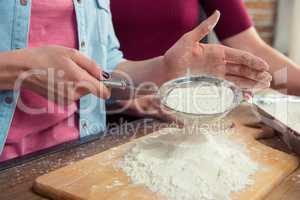 Woman sifting flour