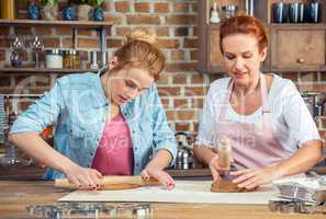 Mother and daughter making gingerbread cookies