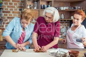 Family preparing gingerbread cookies