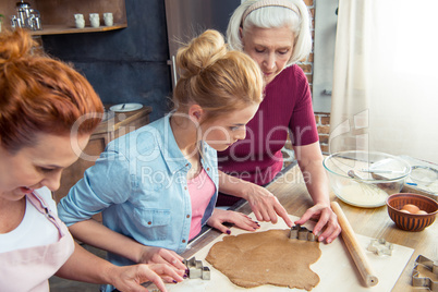 Family preparing gingerbread cookies