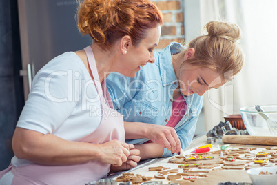 Mother and daughter making cookies