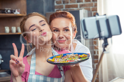 Mother and daughter making selfie