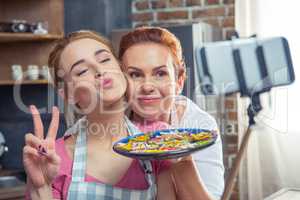 Mother and daughter making selfie