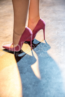 Female legs in pink shoes