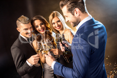 Happy friends drinking champagne