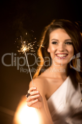 Beautiful woman holding sparkler