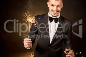 Handsome man holding sparkler