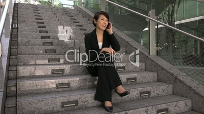 Portrait Of Happy Beautiful Asian Female Manager With Mobile Telephone