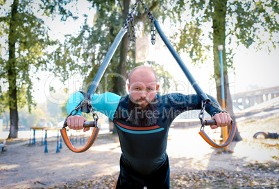 Young man training at outdoor gym