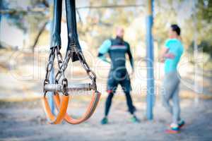 Couple working out with sport equipment on foreground