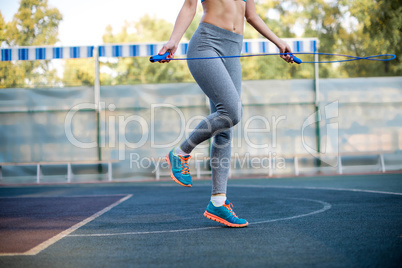 Woman jumping rope at stadium