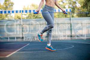 Woman jumping rope at stadium