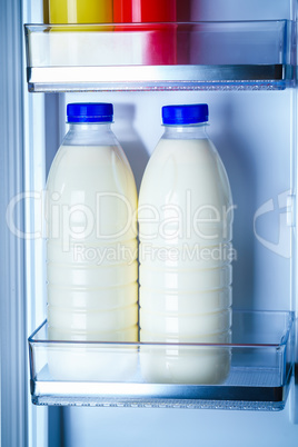 Bottles of milk in the fridge