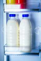 Bottles of milk in the fridge