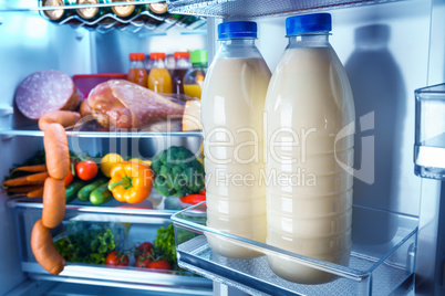 Open refrigerator filled with food