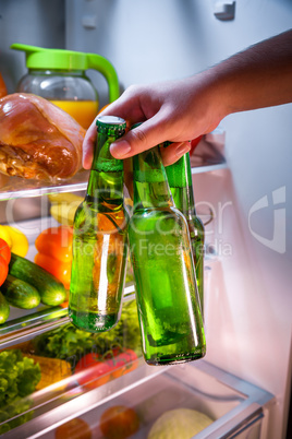 Man taking beer from a fridge