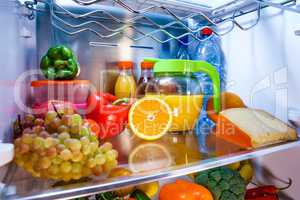 Open refrigerator filled with food