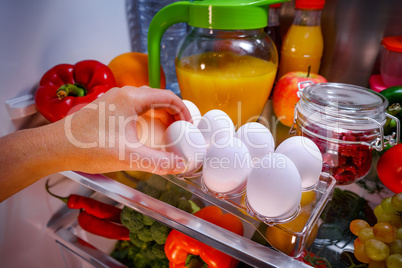 Chicken eggs on a shelf open refrigerator