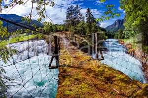 Suspension bridge over the mountain river, Norway.