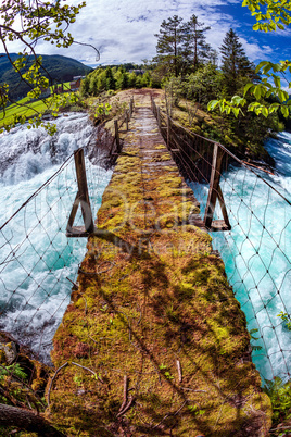 Suspension bridge over the mountain river, Norway.