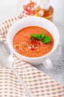 Bowl of fresh tomato soup gazpacho on a napkin