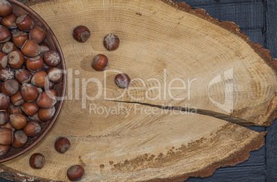 Hazelnut in shell on a brown wooden surface