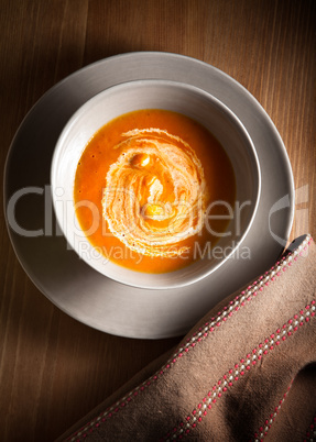 Pumpkin soup with sour cream on the table