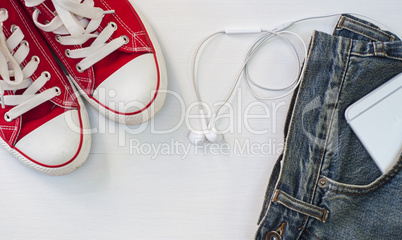 Red sneakers with blue jeans, a smartphone in your pocket, a top