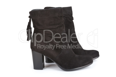 Black ankle boots with a tassel isolated on white
