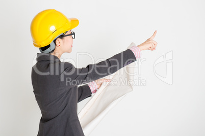 Female engineer pointing away