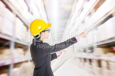 Store manager counting stock in warehouse