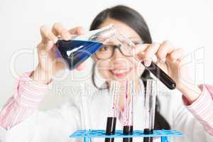 Young female scientist doing experiment in lab