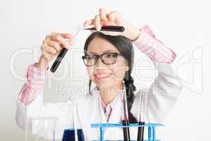 Young Asian female scientist doing experiment