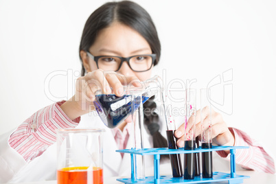 Young Asian female scientist doing experiment in lab