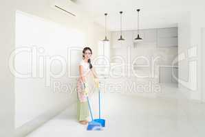 Woman Cleaning house with broom