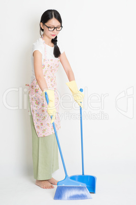 Woman Cleaning floor with broom