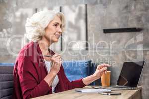 Senior woman holding pen