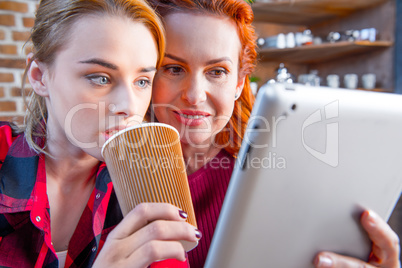 Women using digital tablet