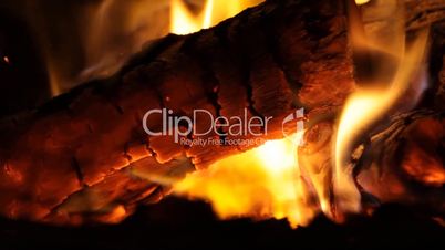 Fireplace full of bright burning wood and embers with the sound