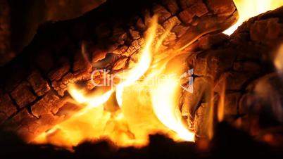 Fireplace full of bright burning wood and embers with the sound