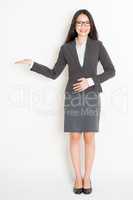 Asian businesswoman showing something