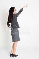 Asian businesswoman pointing away