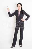 Asian businesswoman finger pointing up