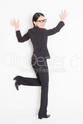 Asian businesswoman hands touching on wall