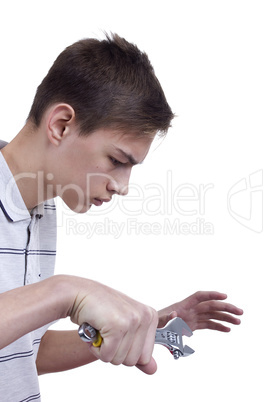Young man holding metal wrench