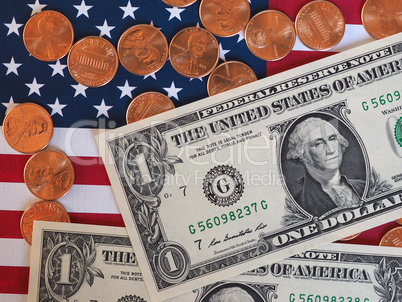 Dollar notes and coins and flag of the United States