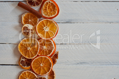 slices of orange on a white wooden surface